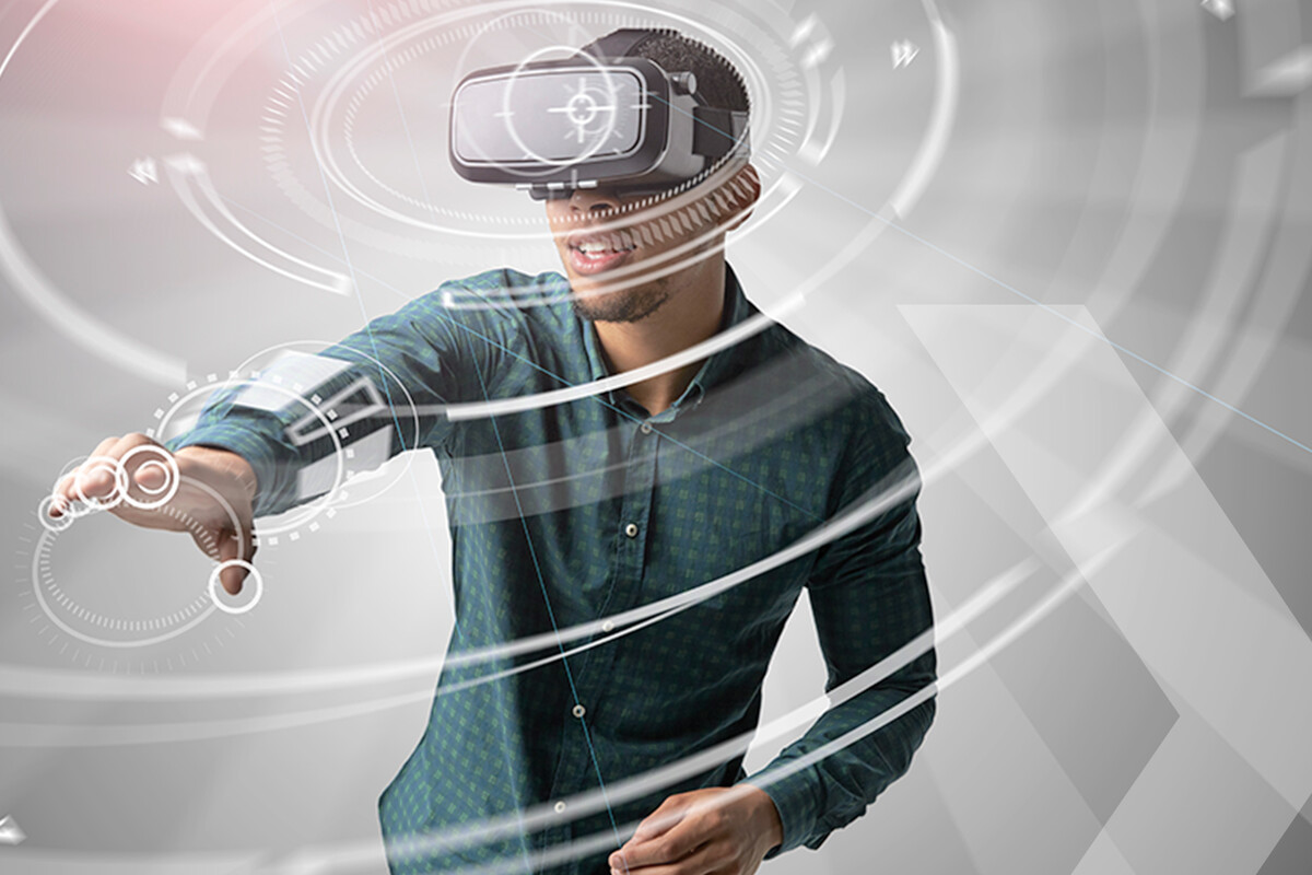 junger Mann mit VR-Brille und VR-Handschuh in virtueller Umgebung