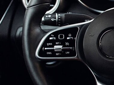 black leather steering wheel with silver shiny switches 