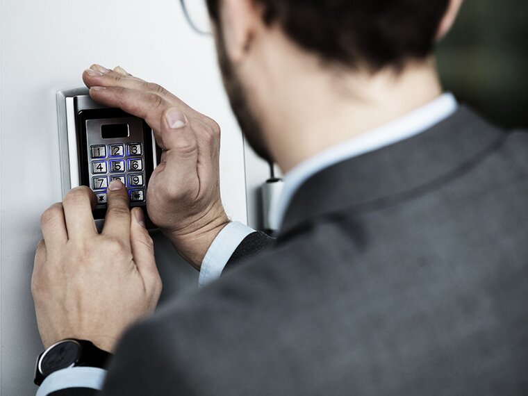 View over the shoulder of a man entering the access code